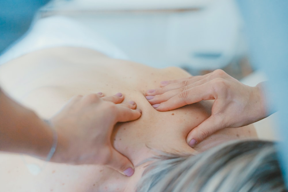A person giving a client a deep tissue massage